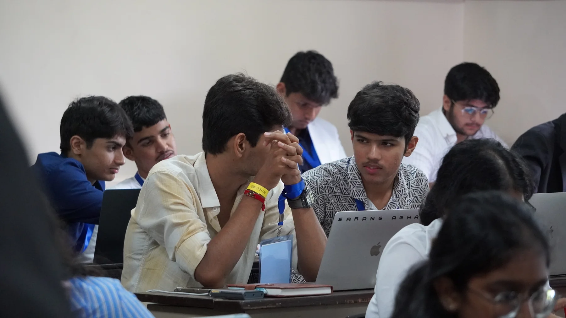 Participants discussing their work around a laptop