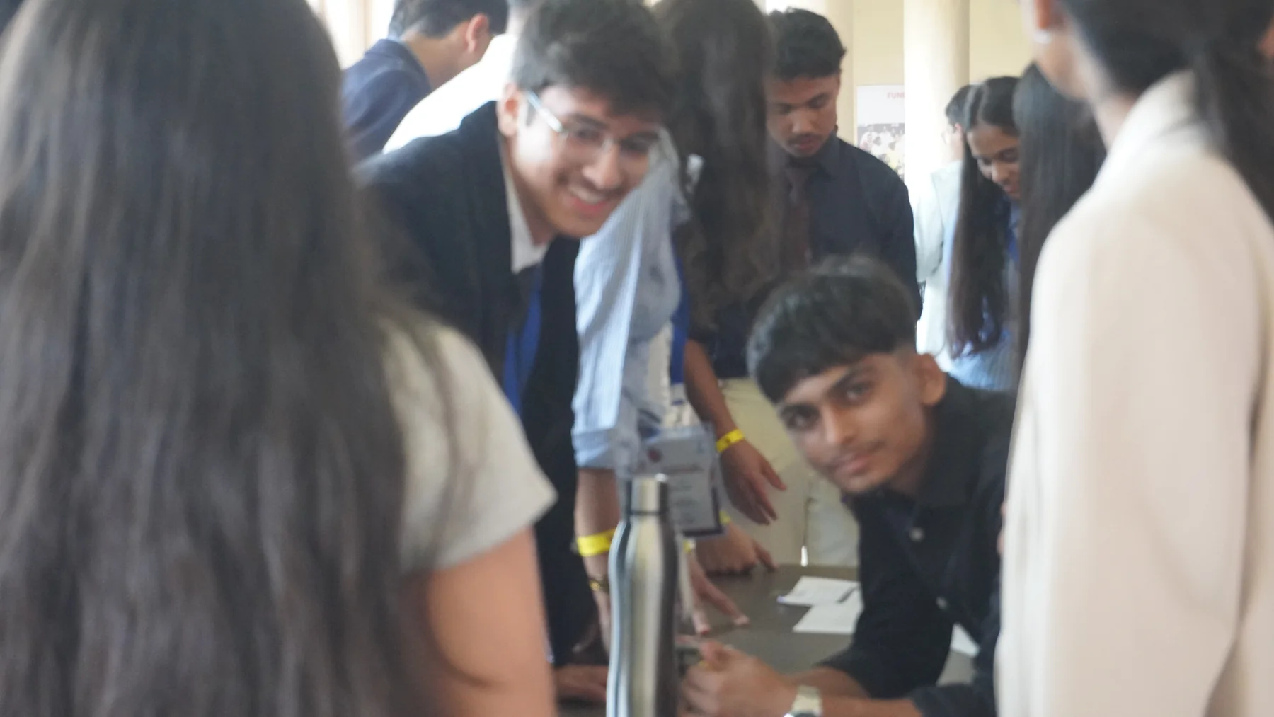 Participants leaning over a table to work together